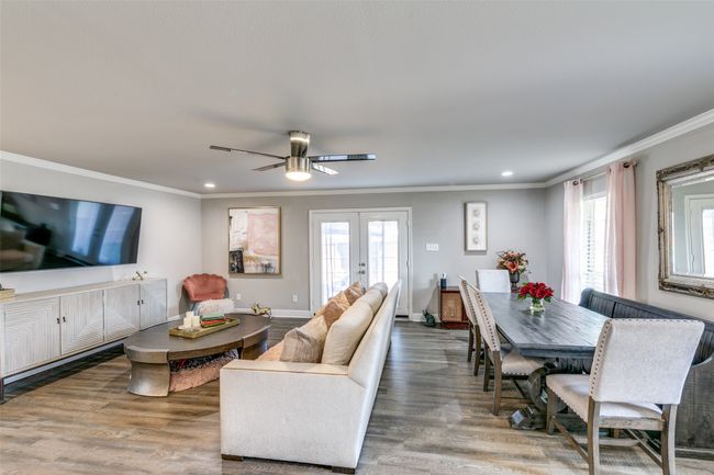 Dining Room shares space with family room. Doors lead out to patio area with fire pit. | Image 4