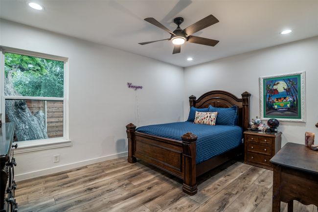 Bedroom with wood finished floors, recessed lighting, and a ceiling fan | Image 25