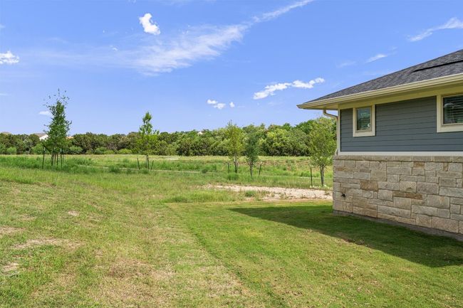 View of yard leading to the greenbelt and walking trail. The neighborhood walking trail is just steps away | Image 26