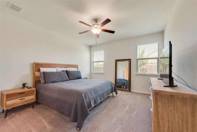 Bedroom featuring light carpet and a ceiling fan | Image 10