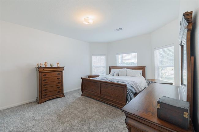 Lovely primary suite boasts high ceilings and an ensuite bath. | Image 14