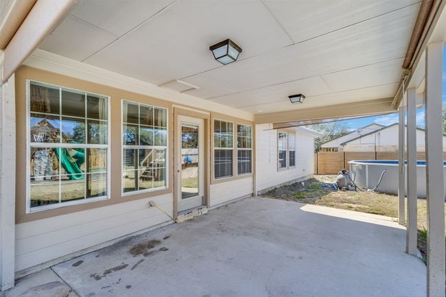 View of patio featuring a fenced in pool and fence | Image 24