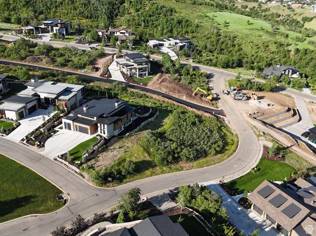 Aerial overview of property's location featuring nearby suburban area and a heavily wooded area | Image 7