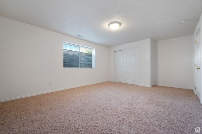Unfurnished bedroom featuring light colored carpet and a closet | Image 24
