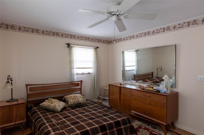 Bedroom featuring a ceiling fan | Image 14