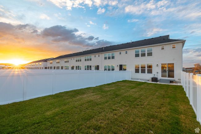 Back house at dusk featuring a mountain view, a patio area, and central air condition unit | Image 32