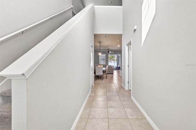 Two story entryway with fresh paint, tile flooring, leading to your open floor plan living room and kitchen. | Image 7