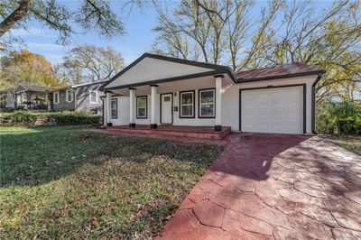 Single story home with a garage, a front yard, and a porch | Image 3