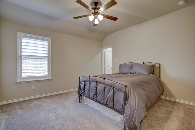 Bedroom featuring carpet, lofted ceiling, and a ceiling fan | Image 32