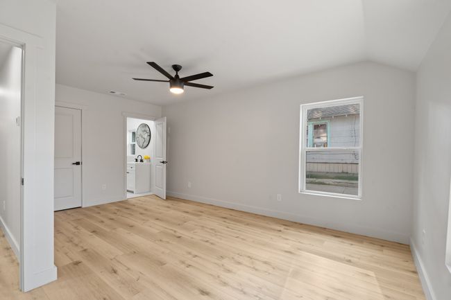 Foyer entrance featuring light wood-style floors, a ceiling fan, baseboards, and lofted ceiling | Image 9