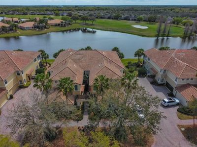 Exquisite Mediterranean style, luxury upstairs condo unit right on the water with a view of the Renaissance Golf Course. | Image 1