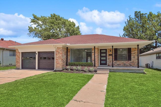 Ranch-style house with covered porch, a front yard, driveway, and an attached garage | Image 4