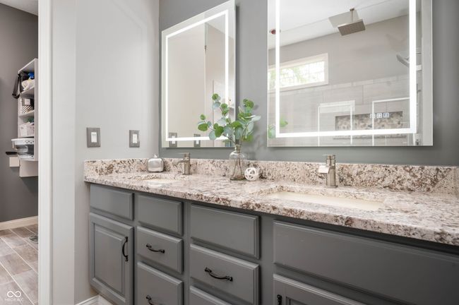 full bath featuring updated double vanity and a walk-in tile shower | Image 16