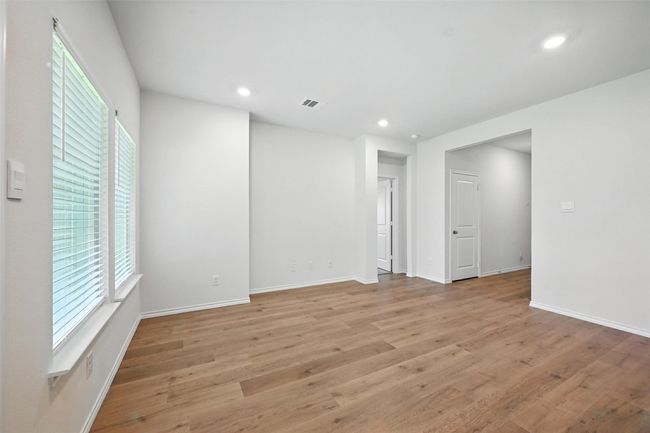Spare room with healthy amount of natural light, light wood-style floors, and recessed lighting | Image 10