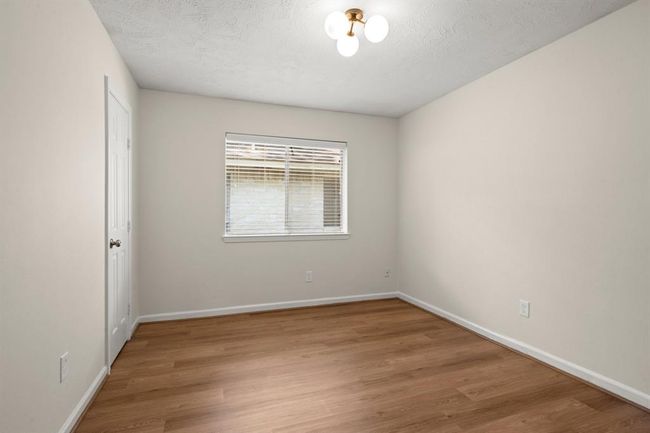 Secondary bedroomvinyl flooring, fresh paint, ceiling fans, updated lighting, and improved closet functionality. | Image 25