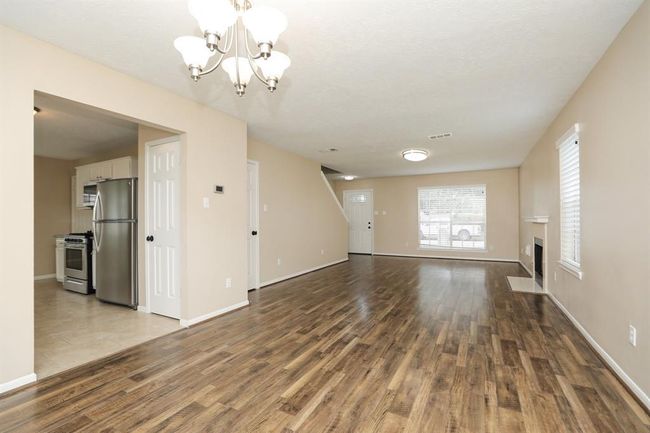 View of living/dining combo and front door. | Image 10