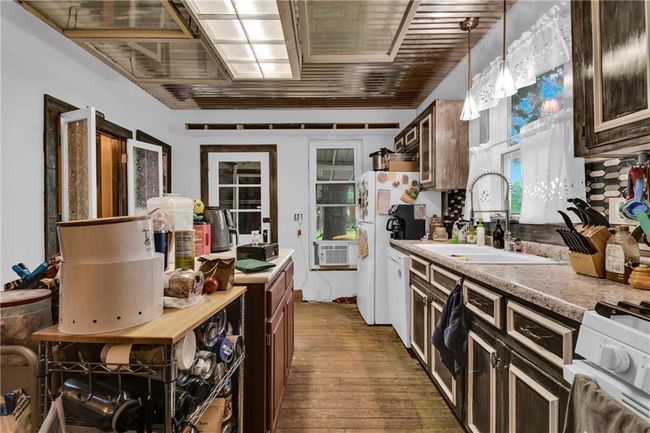 Kitchen with light countertops, dark wood-type flooring, and pendant lighting | Image 6