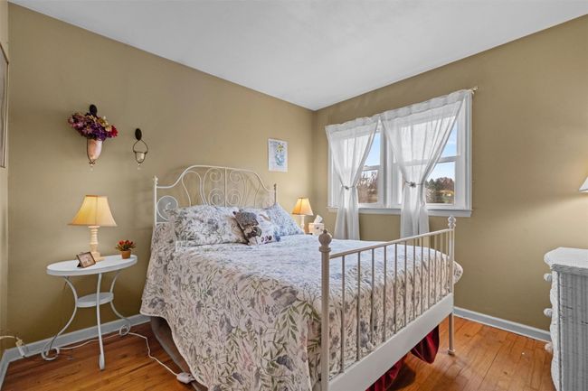 Bedroom with wood-type flooring and baseboards | Image 15