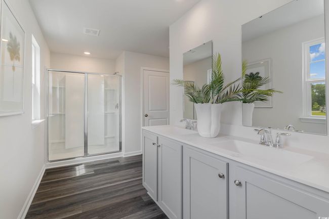 Bathroom featuring a shower stall, wood finished floors, double vanity, baseboards, and recessed lighting | Image 18