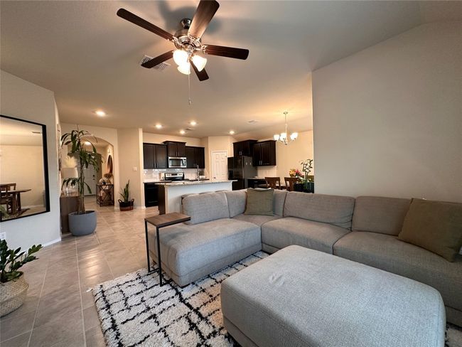 Living area with ceiling fan, light tile patterned floors, a chandelier, arched walkways, and recessed lighting | Image 26