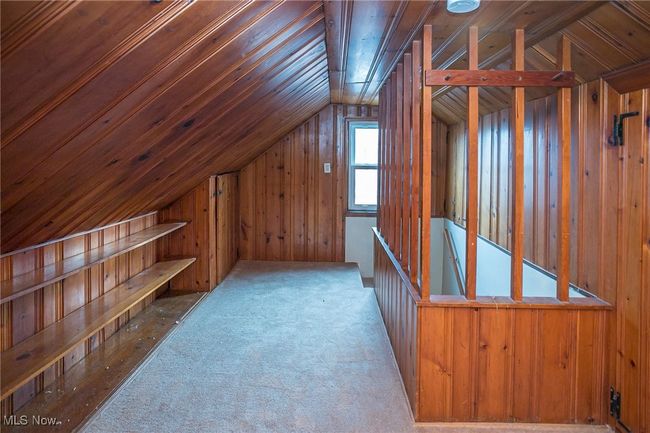 Bonus room with lofted ceiling, wood walls, and carpet | Image 29