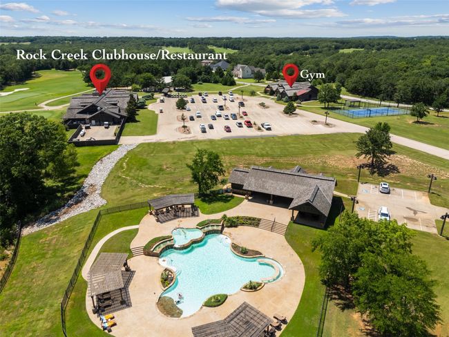 Bird's eye view of a pool area and a forest | Image 8