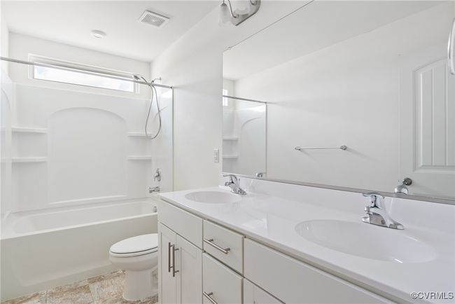 Full bathroom featuring visible vents, a sink, double vanity, and toilet | Image 24