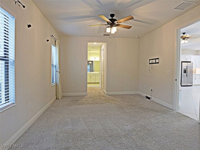 Spare room with a ceiling fan, light colored carpet, and baseboards | Image 14