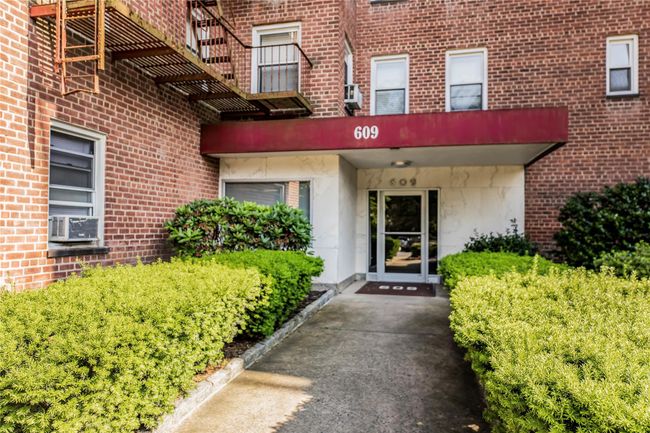 Property entrance featuring cooling unit and brick siding | Image 4