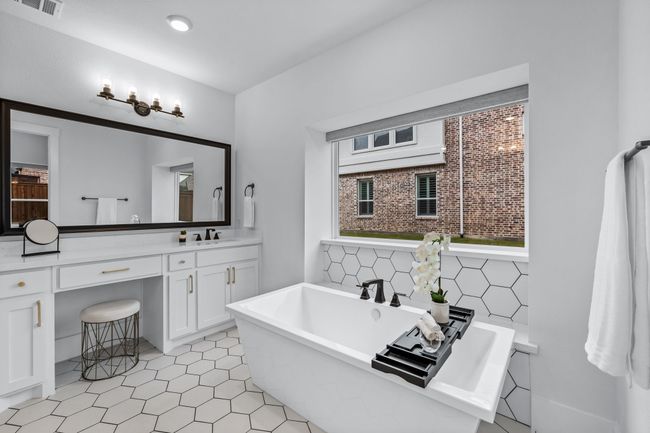 Bathroom with vanity, tile patterned flooring, and a bath | Image 22