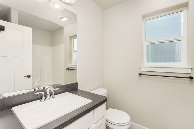 Bathroom with visible vents, toilet, and vanity | Image 12