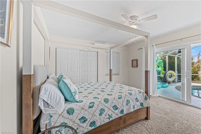 Bedroom featuring carpet, a closet, ceiling fan, and access to exterior | Image 10