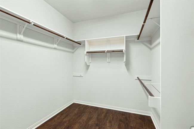 Spacious closet featuring dark wood-style floors | Image 17