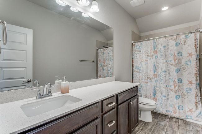 Bathroom featuring vanity, wood finished floors, and curtained shower | Image 17