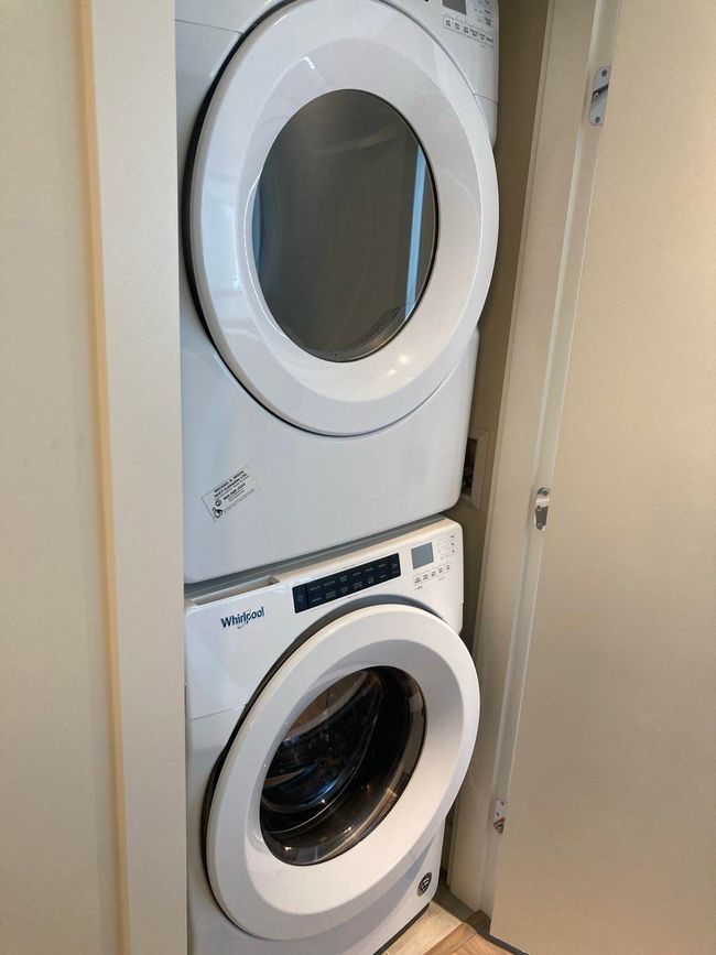 Laundry room with stacked washer and clothes dryer and laundry area | Image 30