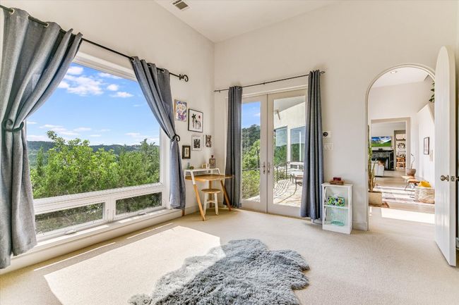 Sitting room featuring french doors, carpet, and arched walkways | Image 17