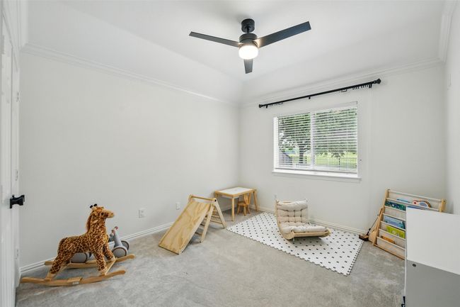 Playroom with carpet floors, ceiling fan, and ornamental molding | Image 25