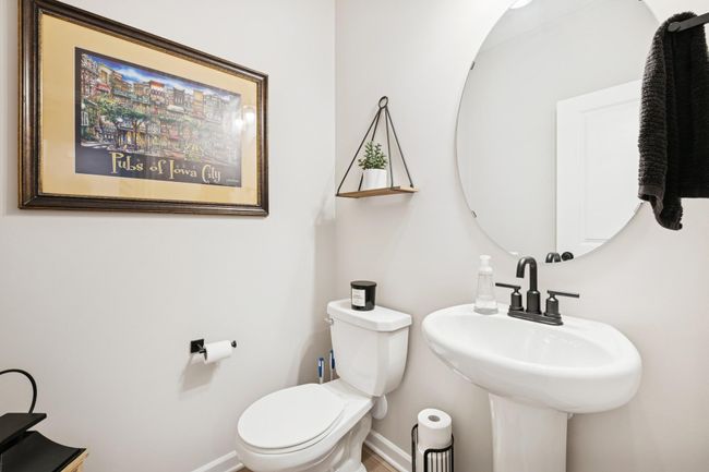 Simple and convenient half bath on the entry level, perfectly located just off the garage and front door for easy access and everyday functionality. | Image 38