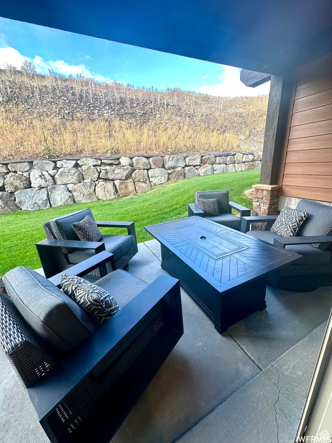 View of patio / terrace featuring an outdoor living space that could be used for things like a fire pit or hot tub | Image 17