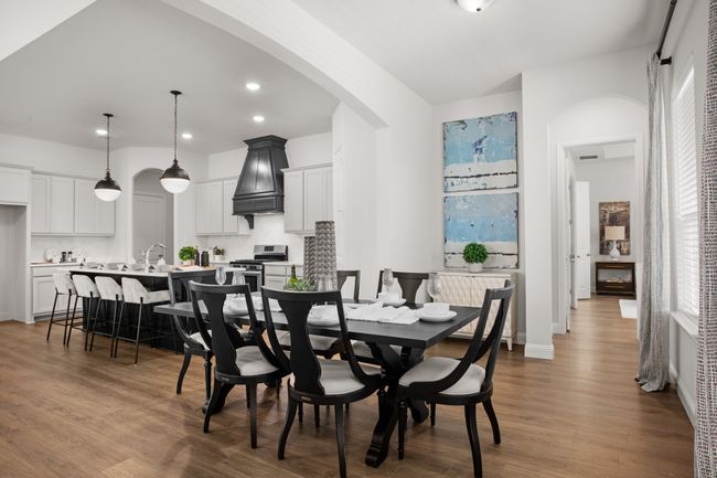 A view of the dining space into the primary wing of the home | Image 19