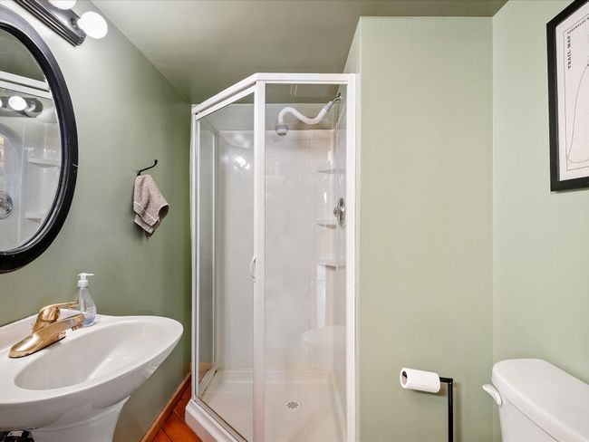 Bathroom featuring a sink, a shower stall, and toilet | Image 16