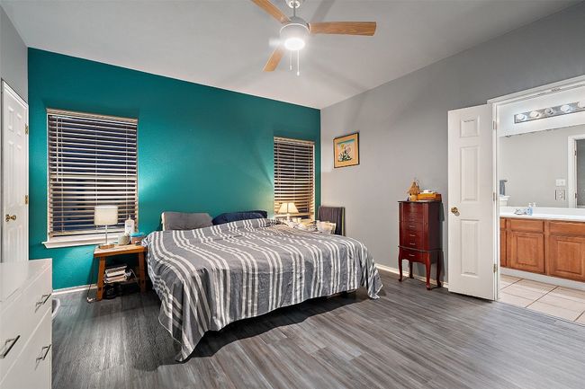 Spacious primary suite on the back of the house for added privacy offers a walk in closet, dual vanities, linen closet plus a window over the shower and tub providing natural light. Recent upgrades include vinyl plank flooring, water heater, range, roof and HVAC. | Image 22