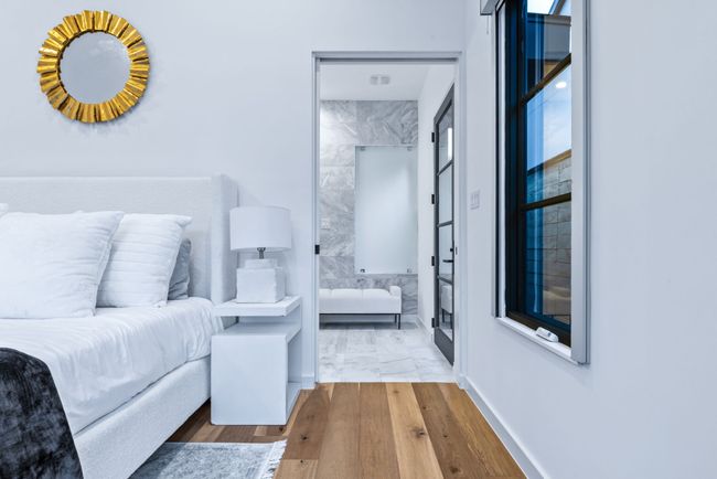 Bedroom with wood finished floors and connected bathroom | Image 19