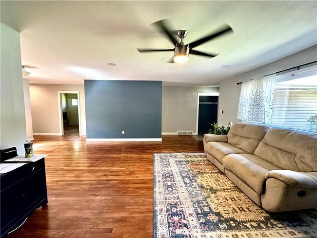 Living room featuring ceiling fan and hardwood / wood-style flooring | Image 13