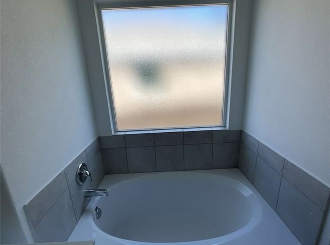 Bathroom with healthy amount of natural light and a bath | Image 22
