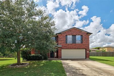 Expansive drive way with partial gutters and gorgeous burnt red bricks sets off the coveted Riverwalk subdivision in Hutto. | Image 2