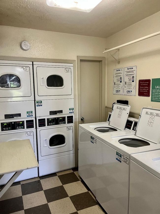Community laundry room with stacked washer and dryer, independent washer and dryer, and tile patterned floors | Image 25
