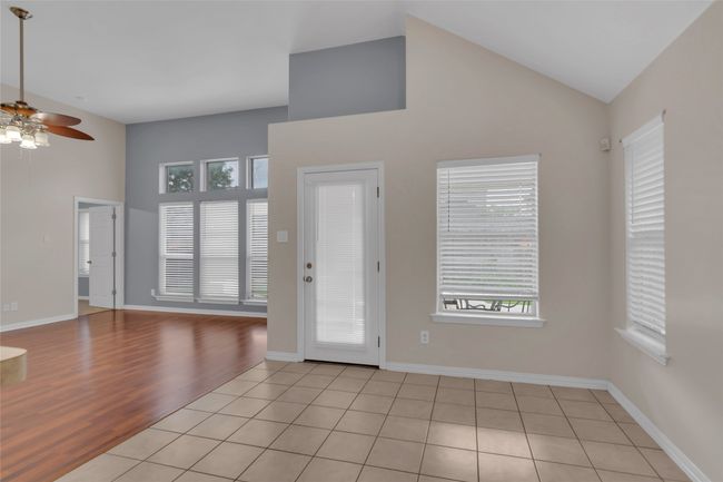 Entrance foyer featuring a ceiling fan, high vaulted ceiling, and light wood-style floors | Image 27