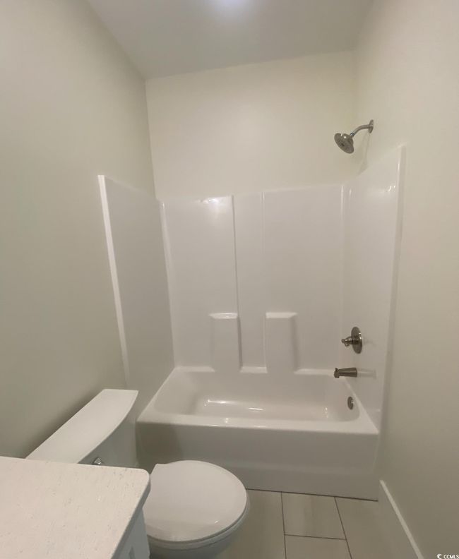 Bathroom featuring tile patterned flooring, vanity, and tub / shower combination | Image 22