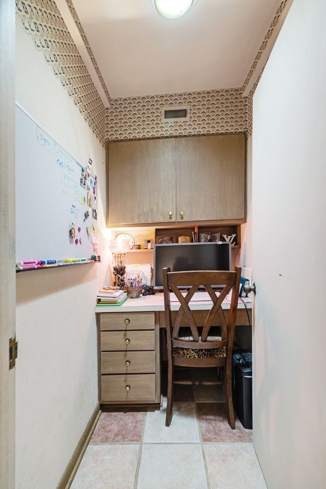 Office featuring built in desk and light tile patterned flooring | Image 23
